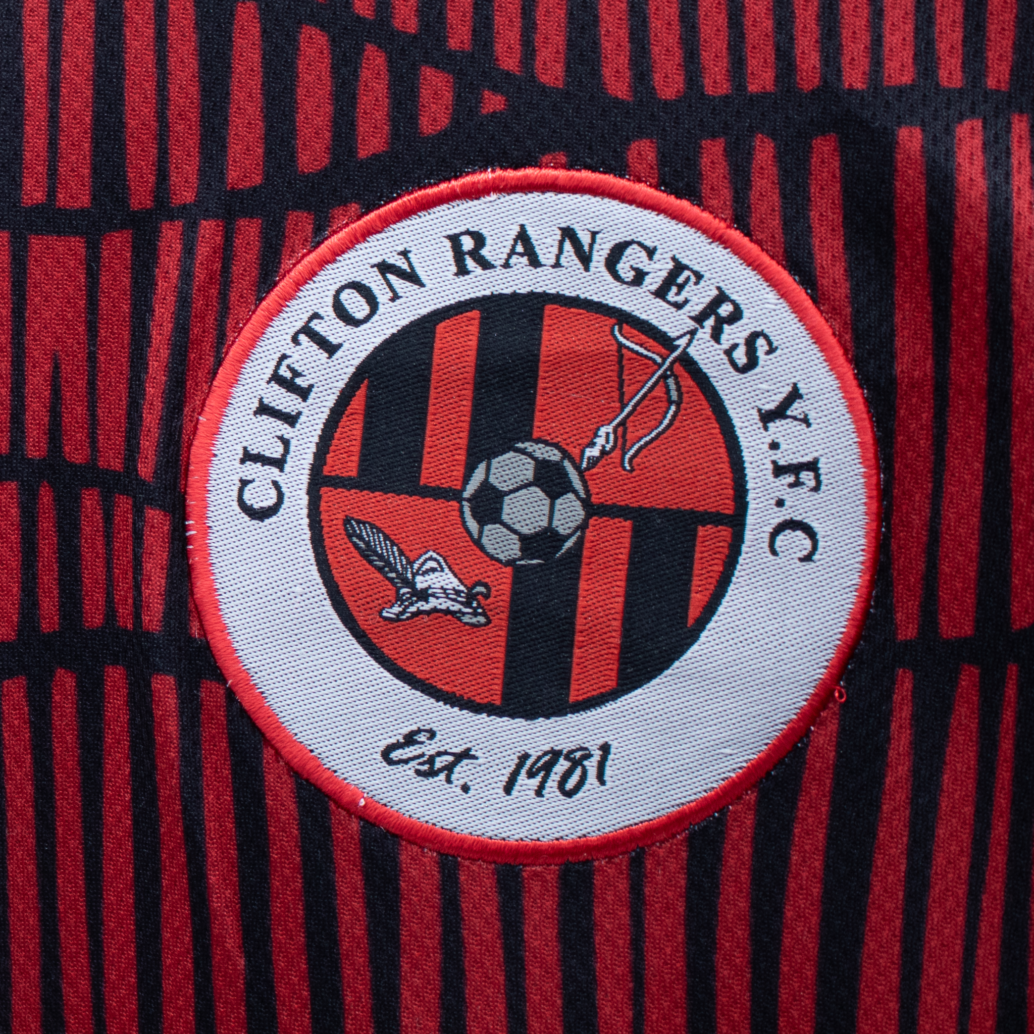 Woven badge attached to sportswear fabric